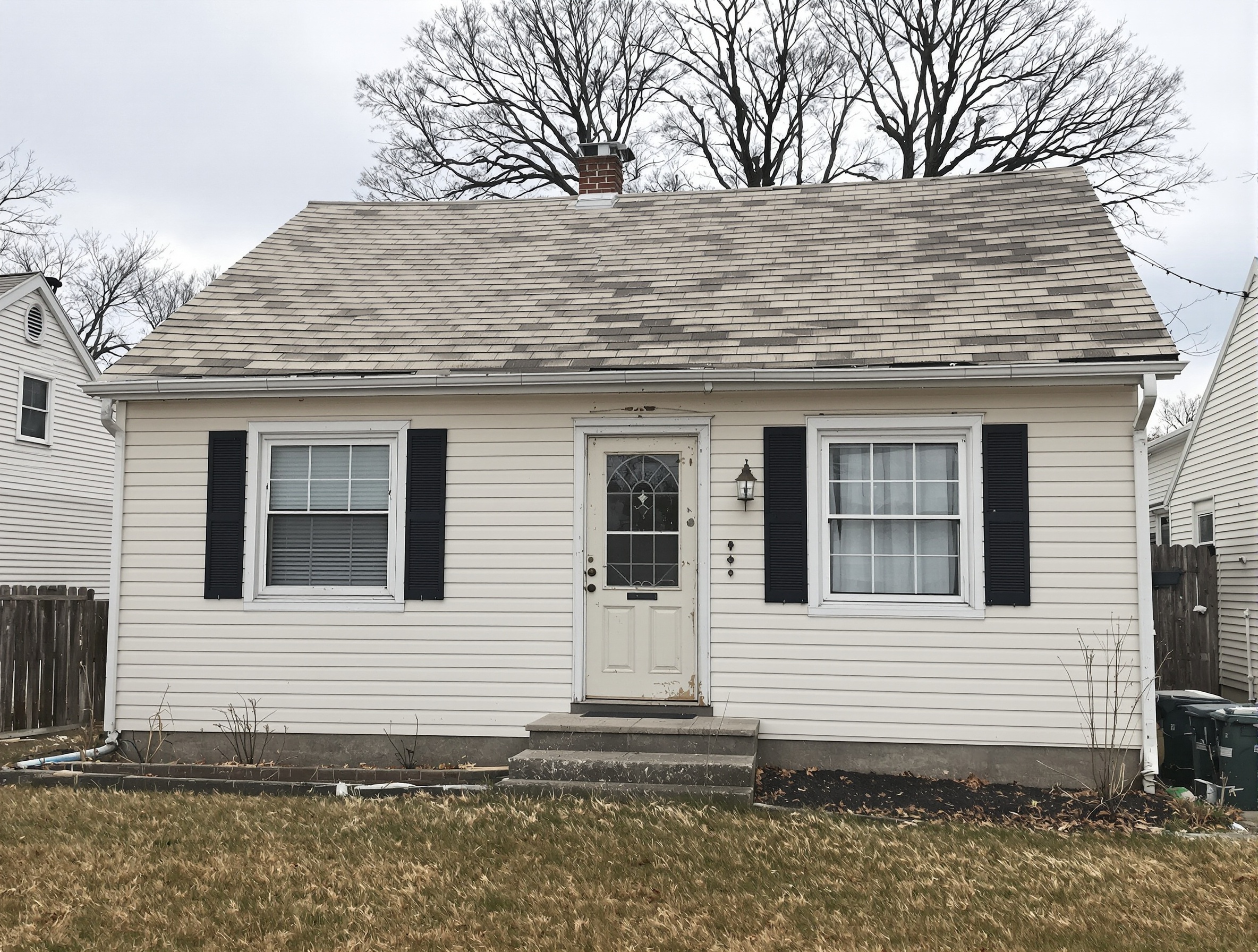 Post-war Levittown cape with original asbestos shingles